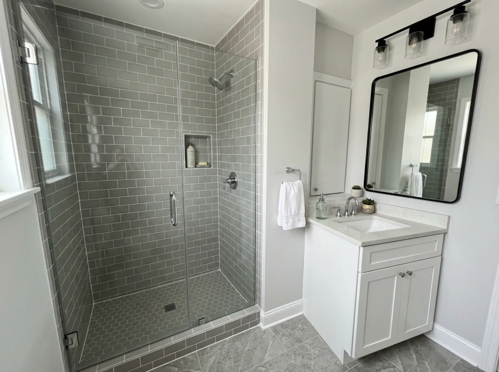 Renovated bathroom with new tile shower and vanity